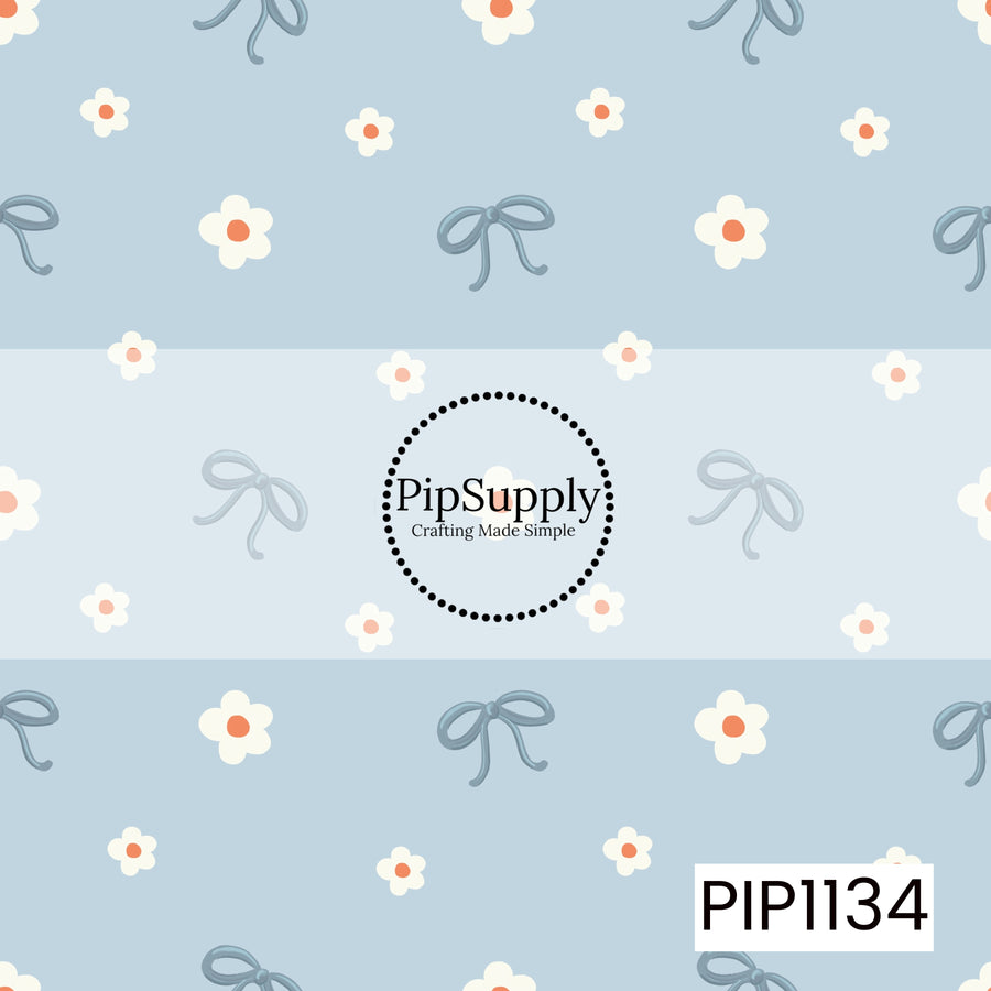 A sweet, airy pattern featuring dusty blue bows and scattered white flowers with coral centers on a soft powder-blue background.
