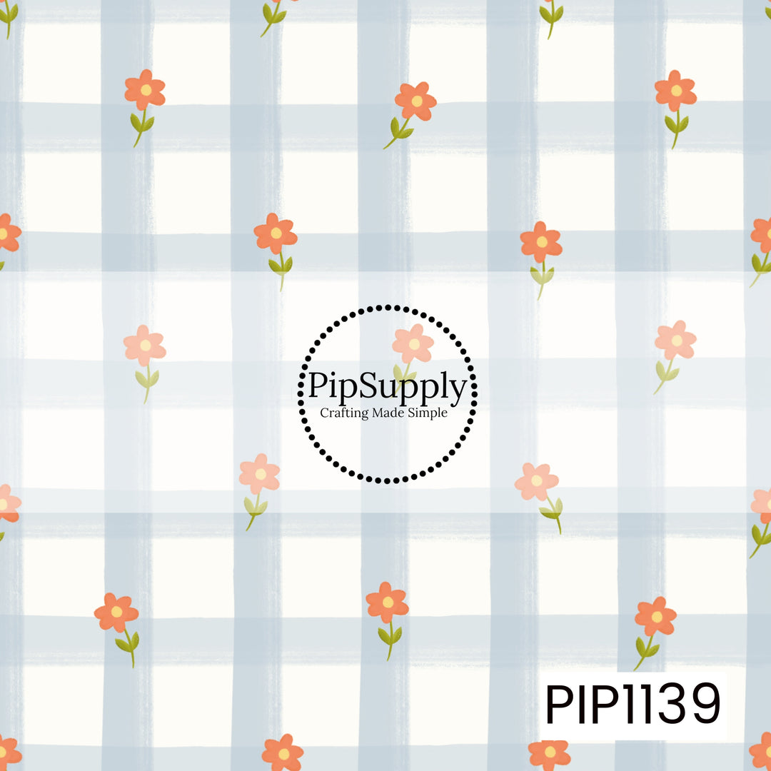A playful hand-painted pattern featuring coral-orange flowers with yellow centers and green leaves scattered across an oversized powder-blue and white checkered background.
