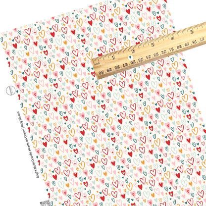 These Valentine's pattern themed faux leather sheets contain the following design elements: red, light pink, aqua, teal, and mustard colored doodle hearts on cream. Our CPSIA compliant faux leather sheets or rolls can be used for all types of crafting projects.