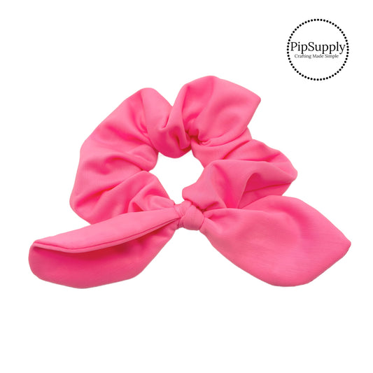 These bright pink swim scrunchies have a two layer swimsuit fabric strip with edges that are securely folded and sewn providing a professional and high quality seam. Fabric is thick high quality not coarse or stiff with elastic band sewn inside for stretch-ability. Pattern visible on all sides. Bow comes pre-tied on scrunchie however is removable to be available as separate bow.