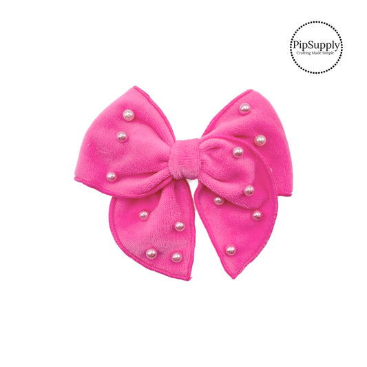 These bubble pink velvet pre-cut bow strips are ready to package and resell to your customers no sewing or measuring necessary! These hair bows come with a alligator clip already attached. The pearls are hand stitched on the pink velvet hair bow.