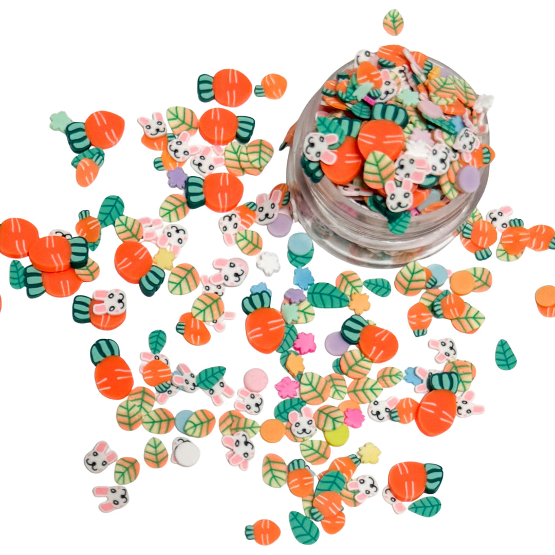 clay pieces shaped as carrots, bunnies, green and orange leaves, and multi colored flowers
 
You can use it to add sparkle and decoration to resin projects, filling for shaker bows, slime making, party decor, scrapbooking, card making and nail art.

 This loose clay mix is sold in a resealable 1 oz Bag

- Material: Polymer Clay and Glitter