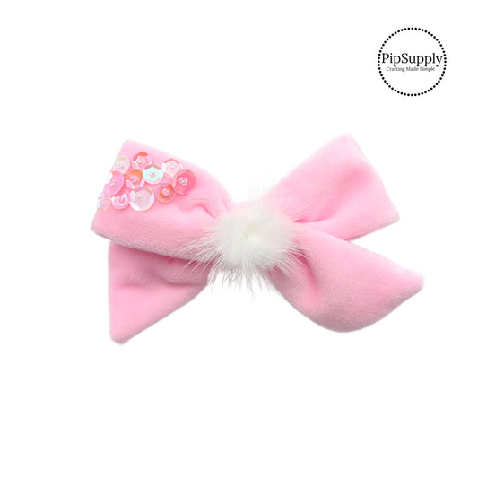 light pink velvet bow with sequins and a white fluffy bunny tail 