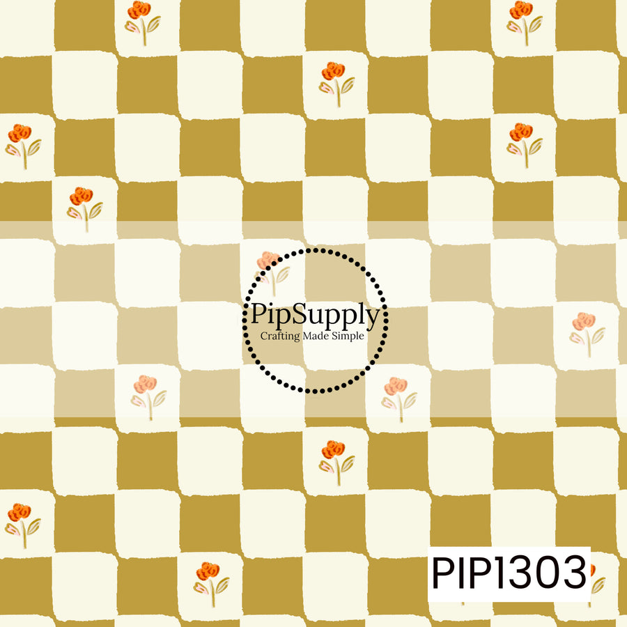 A hand-drawn checkerboard pattern in warm mustard and creamy ivory, accented with scattered petite orange florals and soft leafy details. The slightly imperfect edges give it a charming, vintage-inspired feel.
