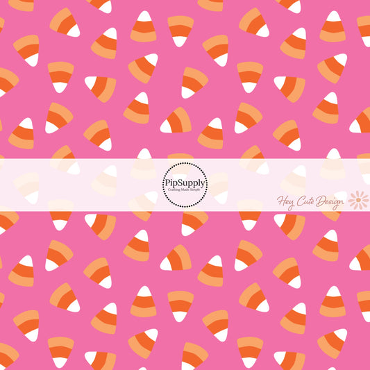 These Halloween themed pink fabric by the yard features candy corn on hot pink. This fun spooky themed fabric can be used for all your sewing and crafting needs! 