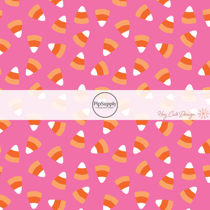 These Halloween themed pink fabric by the yard features candy corn on hot pink. This fun spooky themed fabric can be used for all your sewing and crafting needs! 