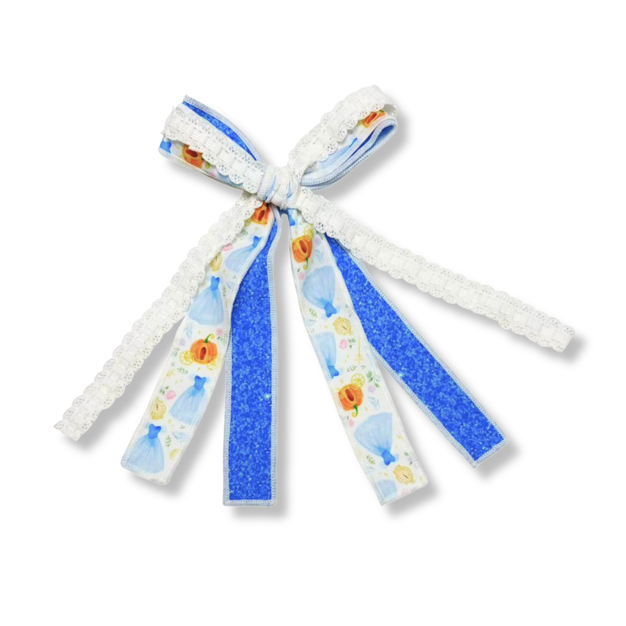 This charming three-ribbon bow combines elegance and fairytale-inspired details in a whimsical design. The bow features a princess-themed ribbon printed with light blue gowns, pumpkins, enchanted clocks, and delicate floral accents on a white background. A vibrant royal blue glitter ribbon adds sparkle and contrast, while a delicate white lace ribbon brings soft texture and vintage charm. The three ribbons are tied together at the center, creating long flowing tails.
Bow Sizing 4" x 8"