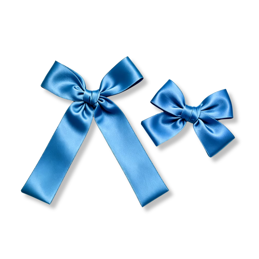 These elegant satin bows feature a rich medium-blue color with a smooth, silky finish that catches the light beautifully. The classic tied design showcases softly structured loops and neatly wrapped centers for a timeless, polished look. Available in both a larger statement size with long flowing tails and a smaller coordinating size.
Small Bow Sizing 4.5" x 4.5"
Large Bow Sizing 5.5" x 7"
