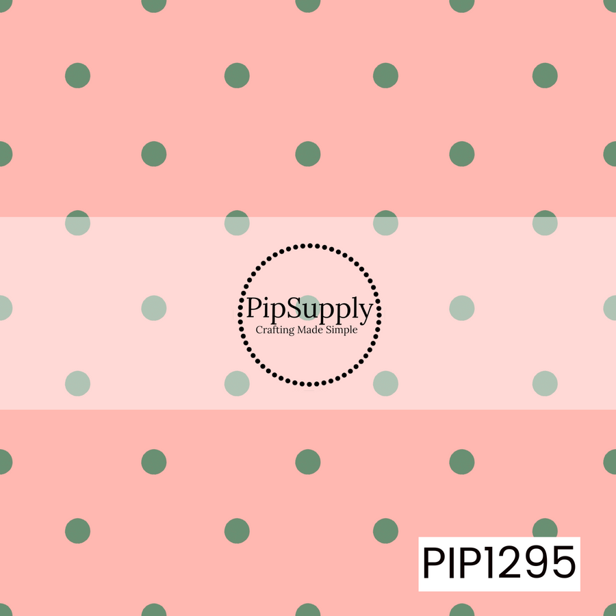 A playful polka dot pattern featuring muted sage green dots evenly scattered across a warm blush pink background. The soft red and green inspired palette gives it a subtle festive feel.
