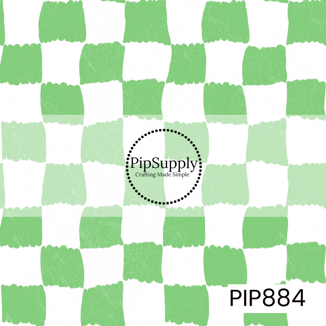 A playful hand-painted checkerboard pattern featuring alternating crisp white and fresh pastel green squares. The checks have irregular, brushstroke-style edges that create an organic, handcrafted appearance. A subtle distressed texture is layered throughout, adding depth and a lightly weathered finish. Clean, bright, and refreshing with a classic yet modern color palette inspired by coastal charm and springtime freshness.
