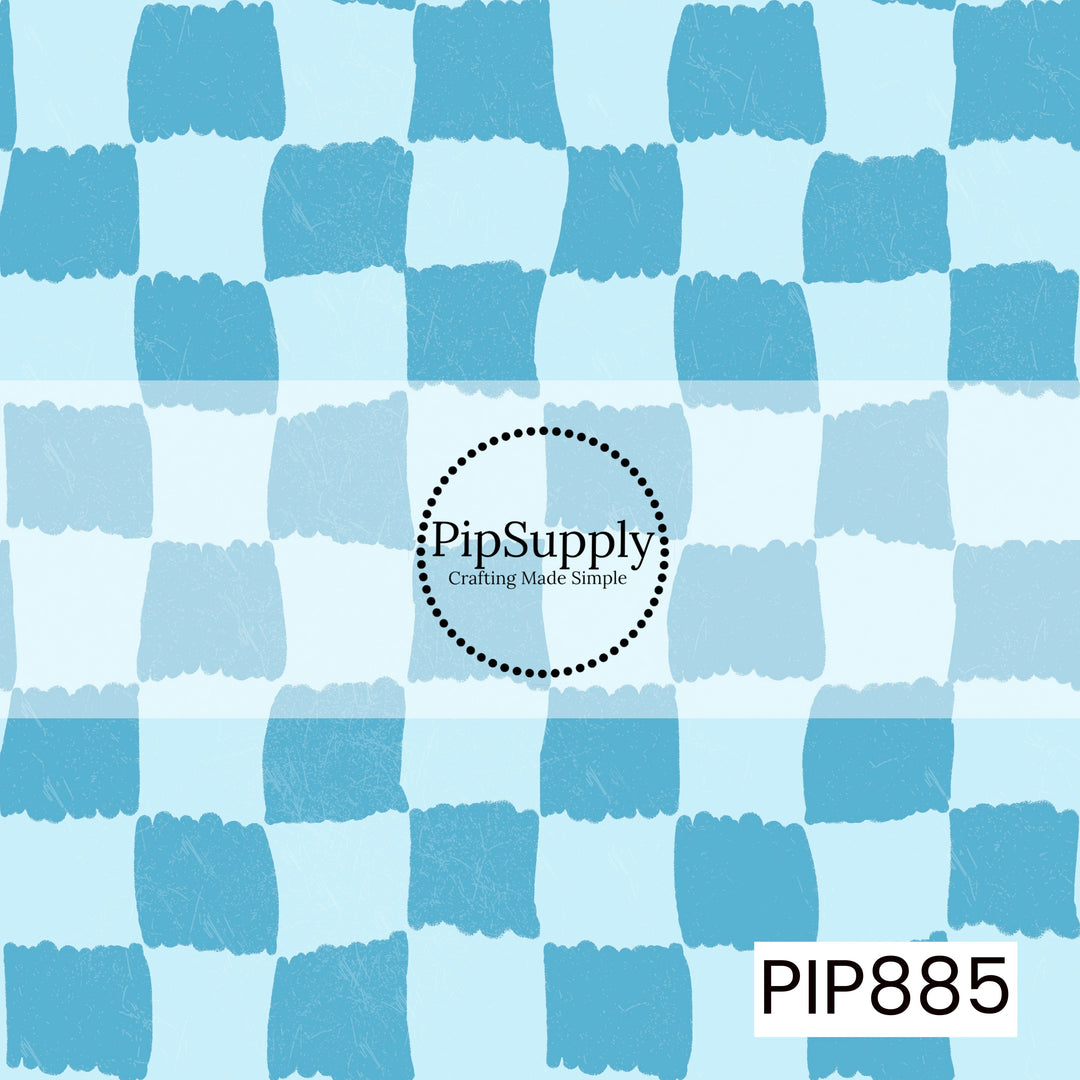 A playful hand-painted checkerboard pattern featuring alternating soft sky blue and vibrant ocean blue squares. The checks have irregular, brushstroke-style edges that create an organic, handcrafted appearance. A subtle distressed texture is layered throughout, adding depth and a lightly weathered finish. Fresh, breezy, and coastal-inspired with a bright blue color palette that evokes clear skies and seaside charm.
