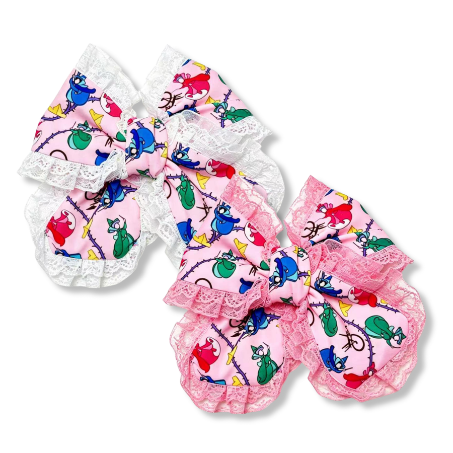 These charming boutique-style bows feature a playful pink character print accented with delicate ruffled lace trim. Available in both white and pink lace variations, the bows combine whimsical cartoon-inspired details with soft pastel colors for a sweet, vintage look. The layered design and gathered lace edging add texture, volume, and elegance, making them perfect for themed outfits, birthdays, character-inspired accessories, and everyday wear with a touch of whimsy.
Small 5" X 6"