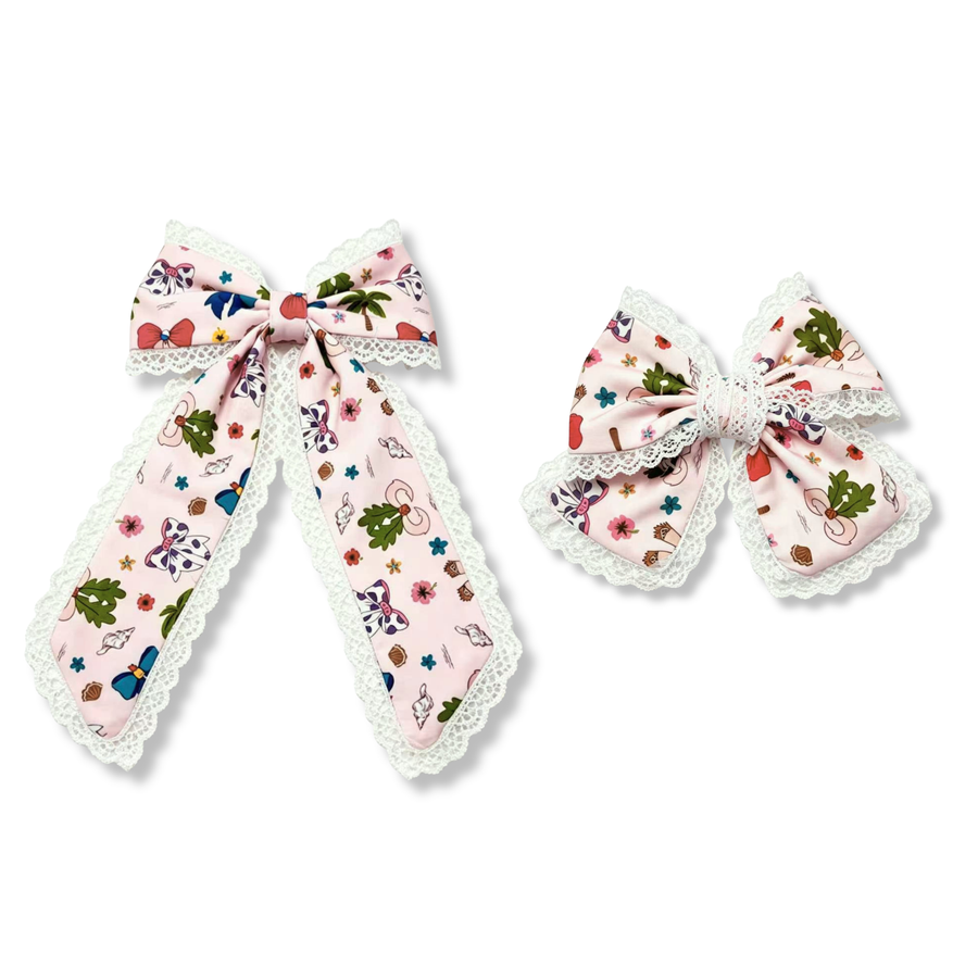 This whimsical boutique bow features a soft blush pink ribbon printed with ocean princess-inspired designs, including seashells, starfish, sea plants and bows. The bow is beautifully layered over delicate white lace trim that frames each loop and tail, adding elegance and texture. A wrapped lace center completes the design, creating a charming focal point. 
SIZE:
Large 5.5" X 9.5"
Small 5" X 6"