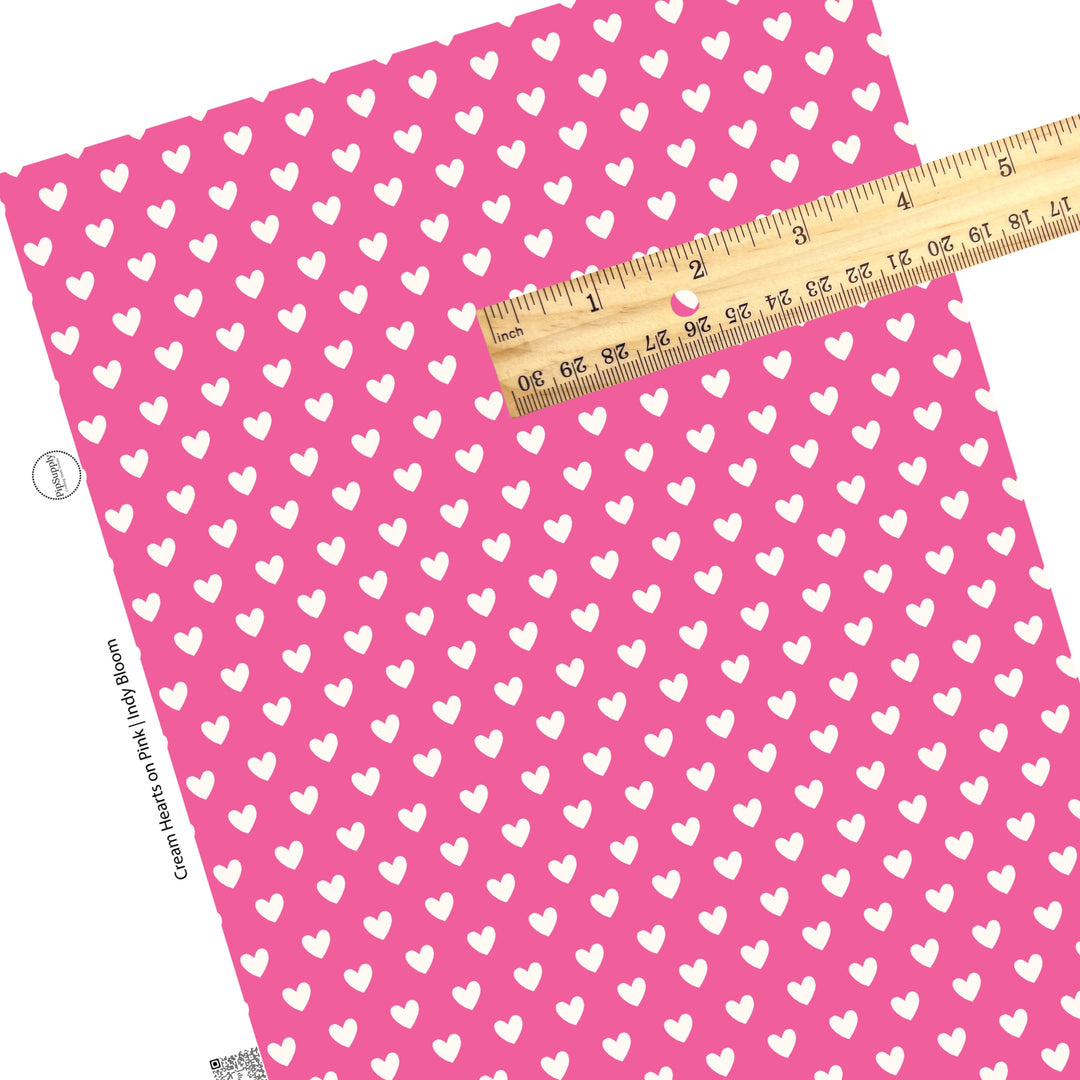 These Valentine's pattern themed faux leather sheets contain the following design elements: white hearts on bright pink. Our CPSIA compliant faux leather sheets or rolls can be used for all types of crafting projects.