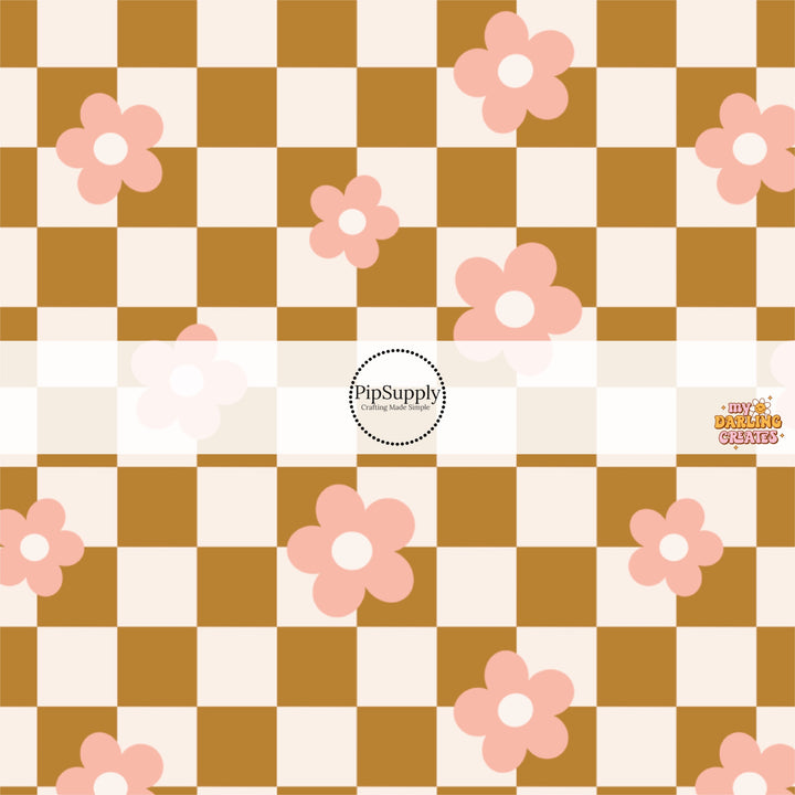 Bronze and white checkered print fabric by the yard with scattered pink daisies.