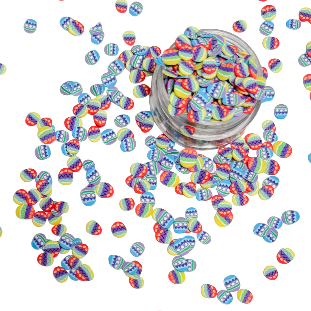 clay pieces shaped as easter eggs that are blue, purple, red, yellow and green
 You can use it to add sparkle and decoration to resin projects, filling for shaker bows, slime making, party decor, scrapbooking, card making and nail art.

 This loose clay mix is sold in a resealable 1OZ Bag

- Material: Polymer Clay and Glitter
