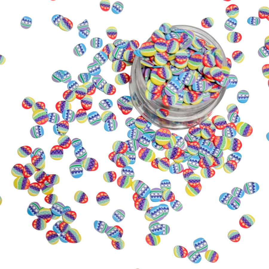 clay pieces shaped as easter eggs that are blue, purple, red, yellow and green
 You can use it to add sparkle and decoration to resin projects, filling for shaker bows, slime making, party decor, scrapbooking, card making and nail art.

 This loose clay mix is sold in a resealable 1OZ Bag

- Material: Polymer Clay and Glitter
