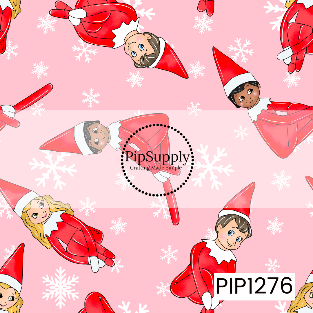 A playful Christmas pattern featuring cheerful little holiday elves dressed in bright red outfits and pointed hats, scattered across a soft pink background. White snowflakes in a mix of sizes fill the spaces between the elves, giving the design a fun, whimsical winter feel.
