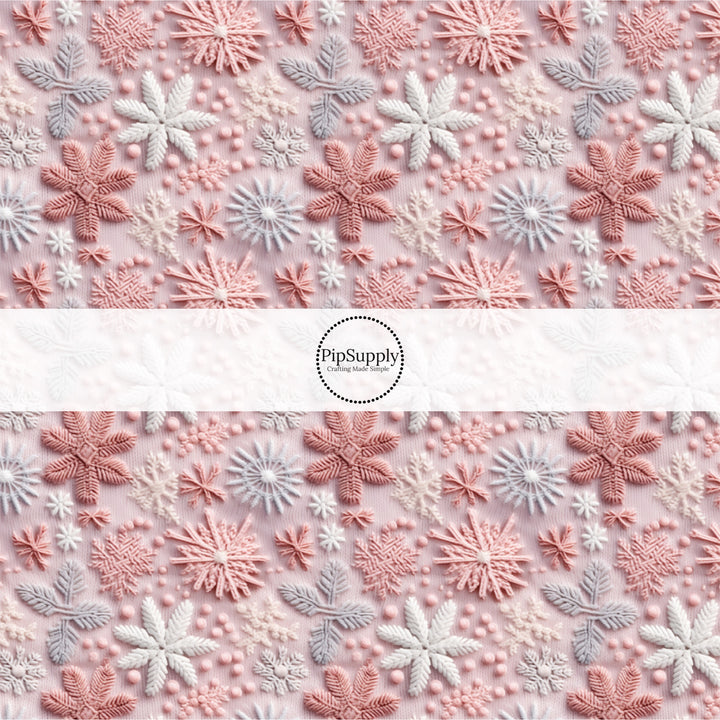 These holiday sewn pattern themed fabric by the yard features pink, purple, and white snowflakes on light pink. This fun Christmas fabric can be used for all your sewing and crafting needs!