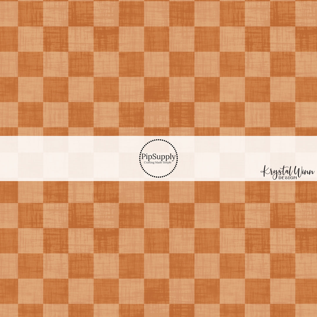 Orange faux linen fabric by the yard with a checker print pattern.