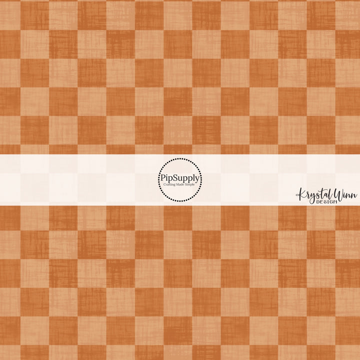 Orange faux linen fabric by the yard with a checker print pattern.