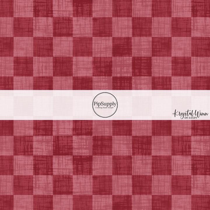 Cranberry red faux linen fabric by the yard with a checker print pattern.