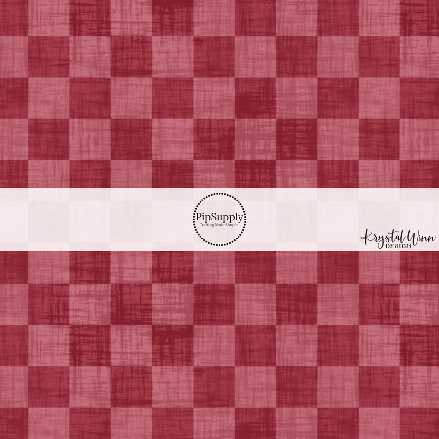 Cranberry red faux linen fabric by the yard with a checker print pattern.