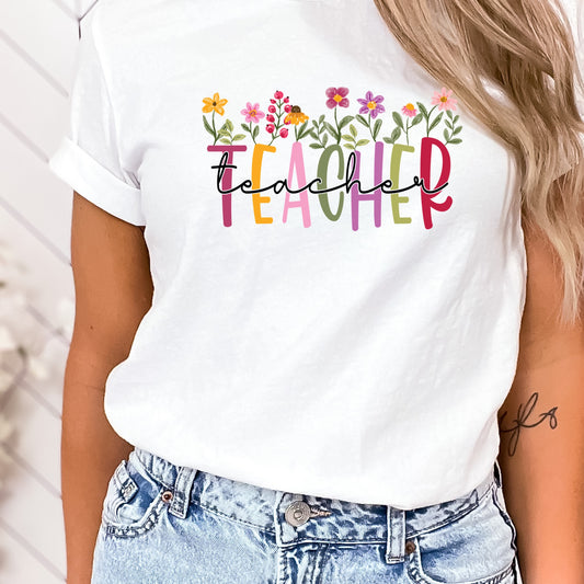 flower blooms above the word "teacher" shirt transfer