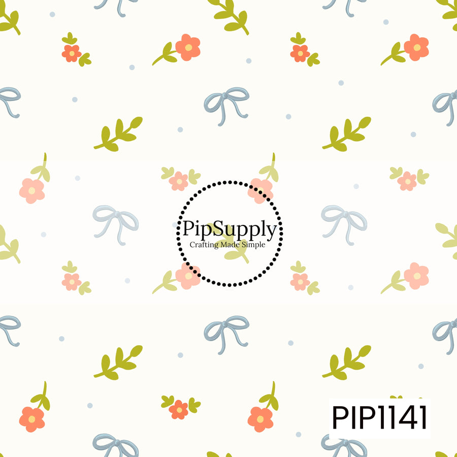 A playful tossed pattern of powder-blue bows, coral-orange flowers, and fresh green sprigs on a warm ivory background, accented with tiny blue dots.
