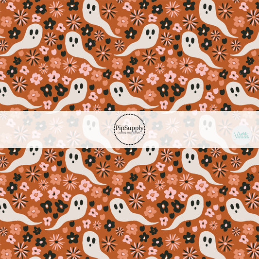 Rust orange fabric by the yard with white ghosts and florals.