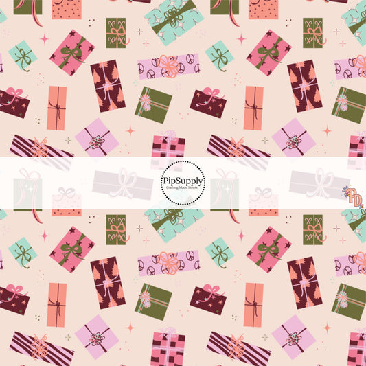 Light pink fabric by the yard with pink, purple, and green Christmas gifts.