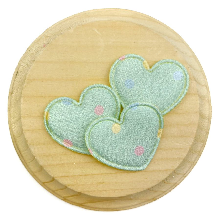 Mint green heart-shaped appliqués featuring scattered pastel polka dots in pink, blue, and yellow.
Heart Appliques
Sets of 3
Approx 35 mm x 25 mm