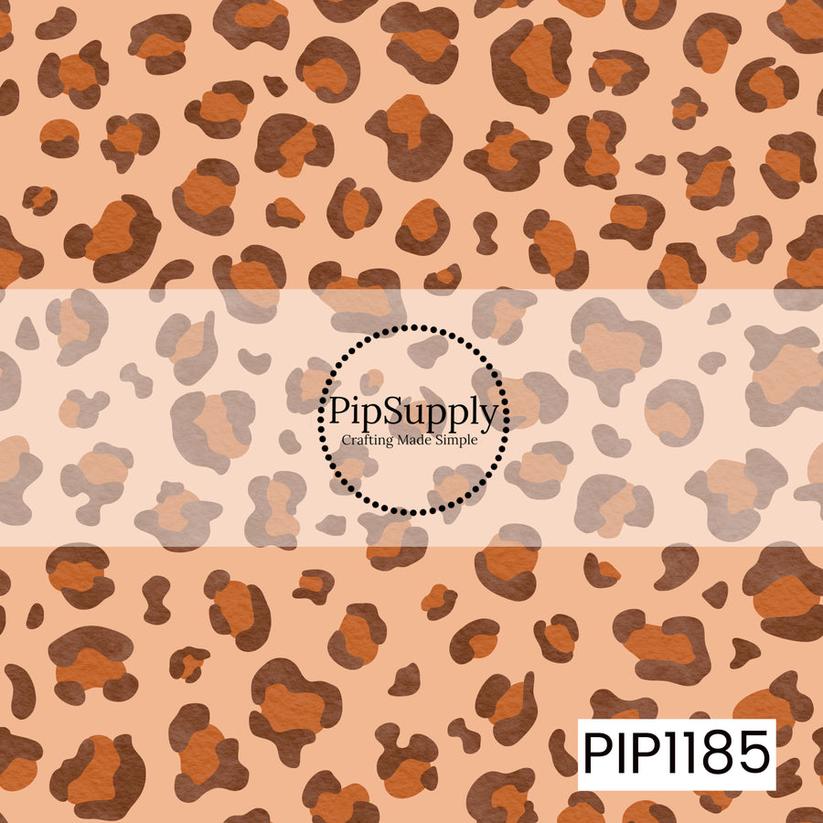 A classic leopard print featuring warm rust and deep brown spots on a soft peach background.

