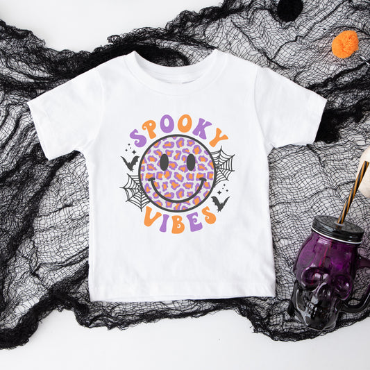 Purple and Orange leopard print smiley face iron on heat transfer that says "Spooky Vibes".