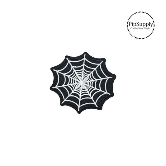 Black and white embroidered spider web iron on patch.