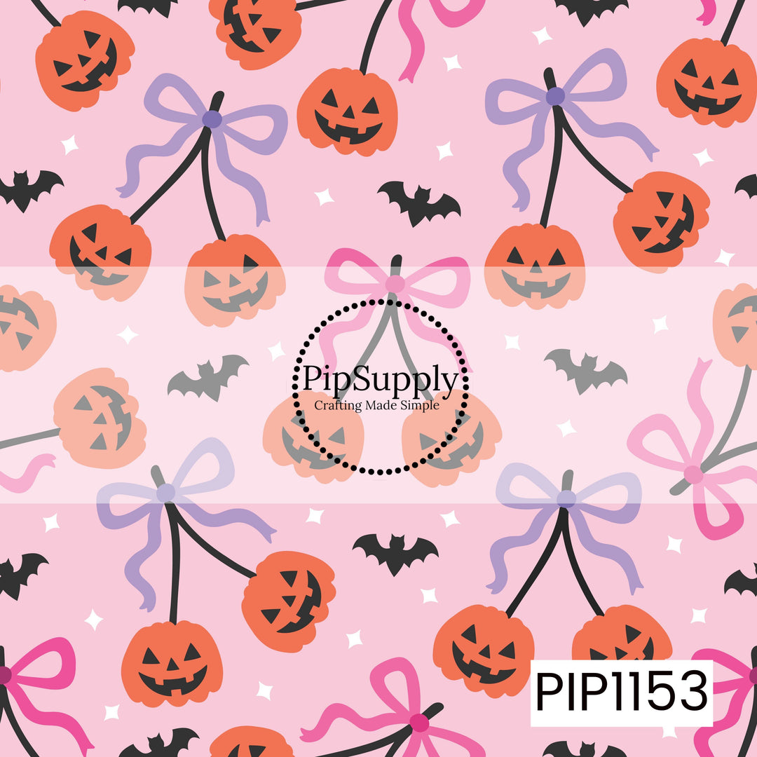 A playful Halloween pattern featuring pairs of smiling jack-o'-lanterns hanging like cherries from black stems tied with pink and lavender bows. The design is scattered with flying bats and white stars across a light pink background, creating a sweet, whimsical Halloween look.
