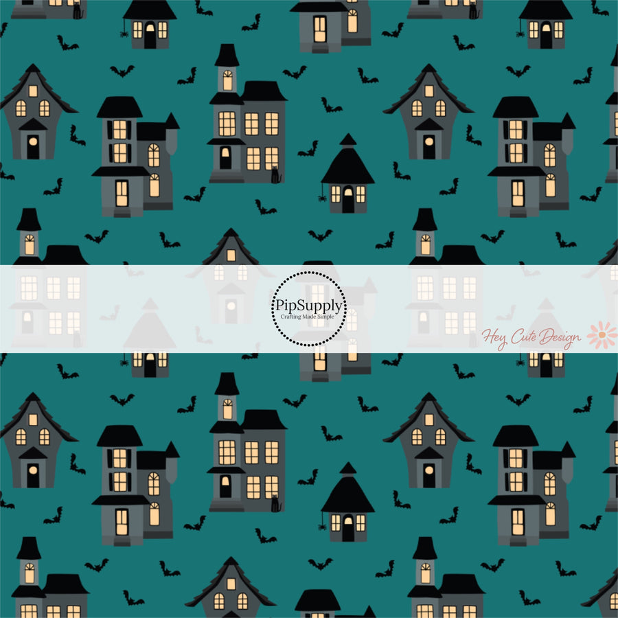 Haunted houses and bats on teal blue fabric by the yard.