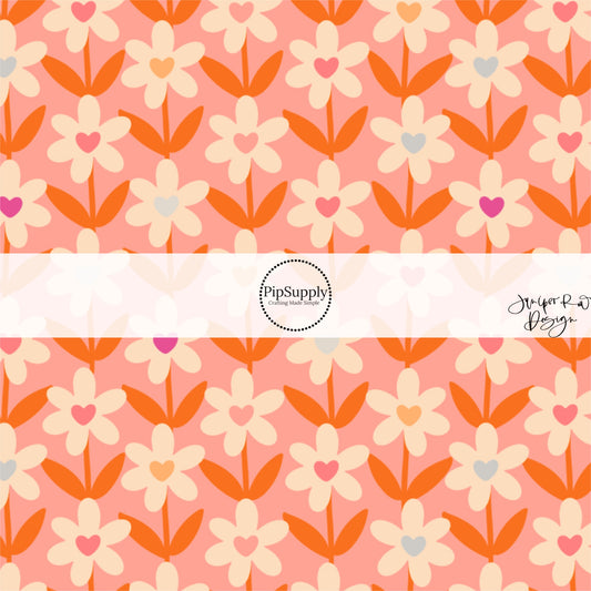 These Valentine's pattern themed fabric by the yard features cream daisies with colorful hearts on peach. This fun Valentine's Day fabric can be used for all your sewing and crafting needs! 