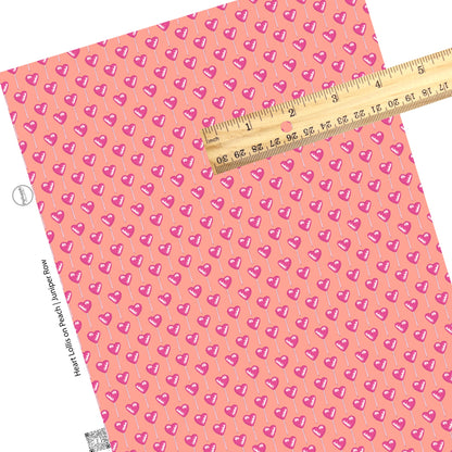 These Valentine's pattern themed faux leather sheets contain the following design elements: pink lollipops on peach. Our CPSIA compliant faux leather sheets or rolls can be used for all types of crafting projects.