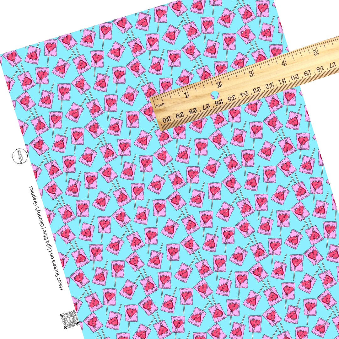 These Valentine's pattern themed faux leather sheets contain the following design elements: heart sucker candy on blue. Our CPSIA compliant faux leather sheets or rolls can be used for all types of crafting projects.