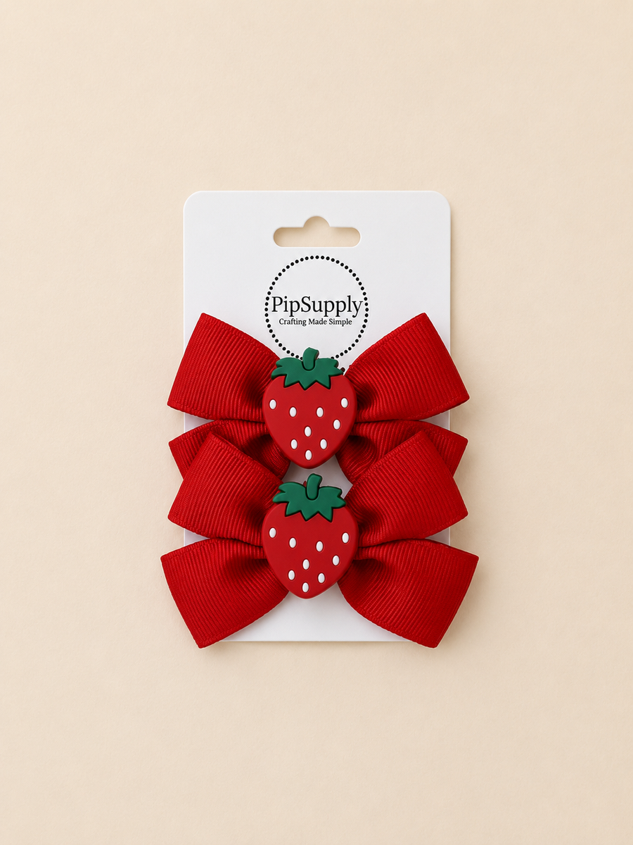 Two red hiar bows with strawberry centers on hair clips. Sized approximately 3.25"
