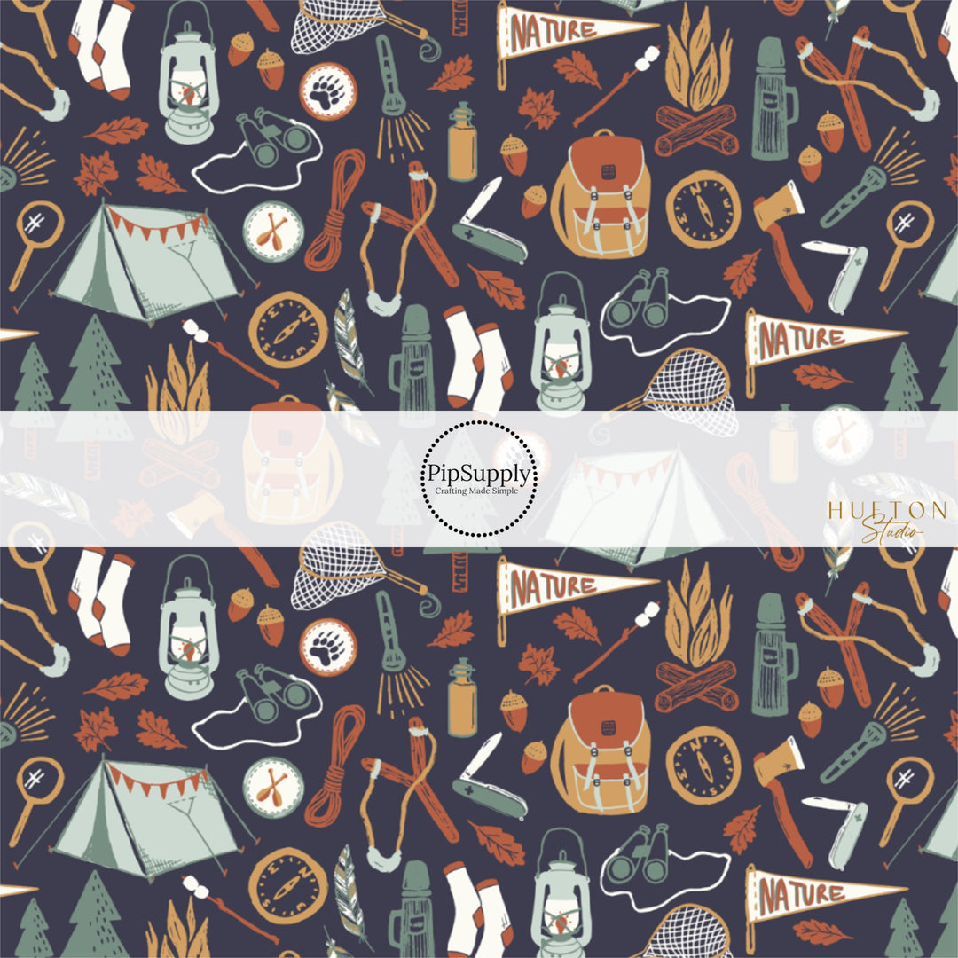 These fall themed fabric by the yard features outdoor adventure items on dark blue. This fun autumn themed fabric can be used for all your sewing and crafting needs! 