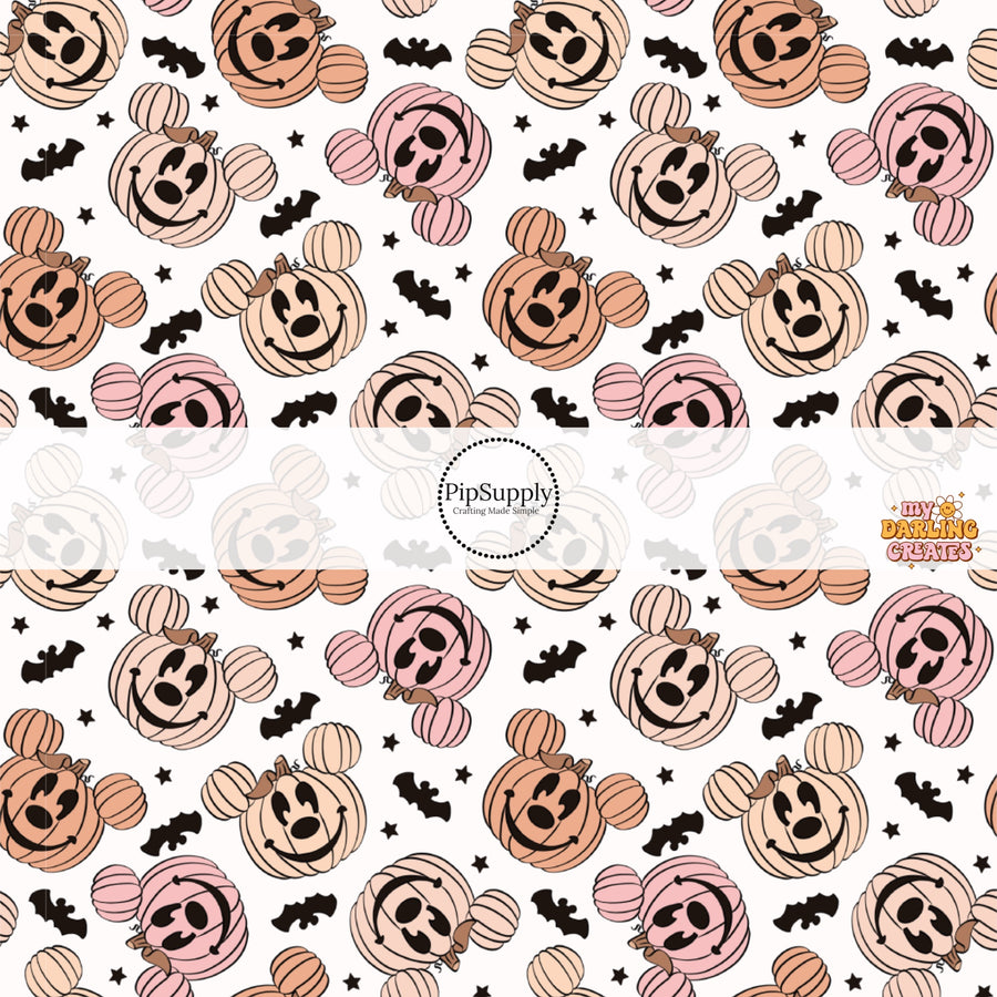 White fabric by the yard with pink and orange mouse jack-o-lanterns, bats, and stars.