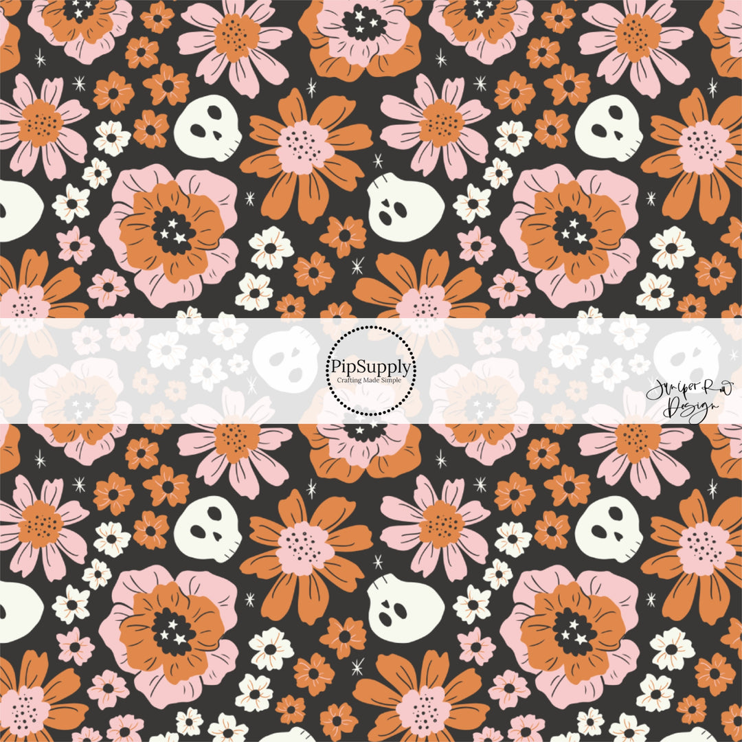 White skeletons and pink and orange floral prints on black fabric by the yard.