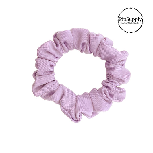 These lavender swim scrunchies have a two layer swimsuit fabric strip with edges that are securely folded and sewn providing a professional and high quality seam. Fabric is thick high quality not coarse or stiff with elastic band sewn inside for stretch-ability. Pattern visible on all sides. 