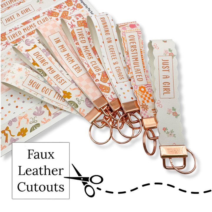 Set of keychains with printed faux leather cutouts on a white background