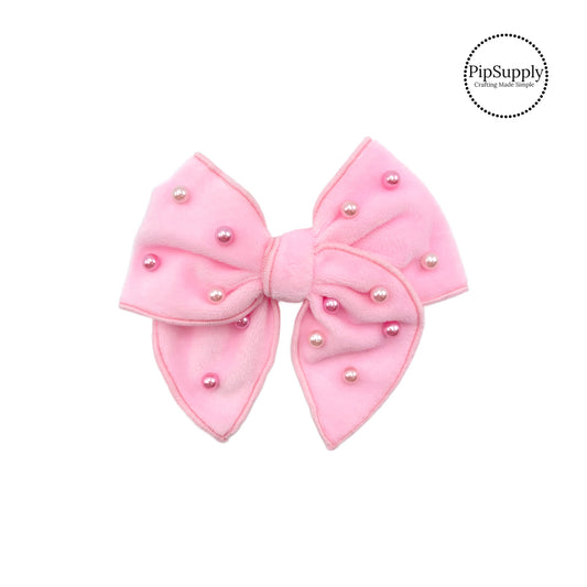 These light pink velvet pre-cut bow strips are ready to package and resell to your customers no sewing or measuring necessary! These hair bows come with a alligator clip already attached. The pearls are hand stitched on the light pink velvet hair bow.