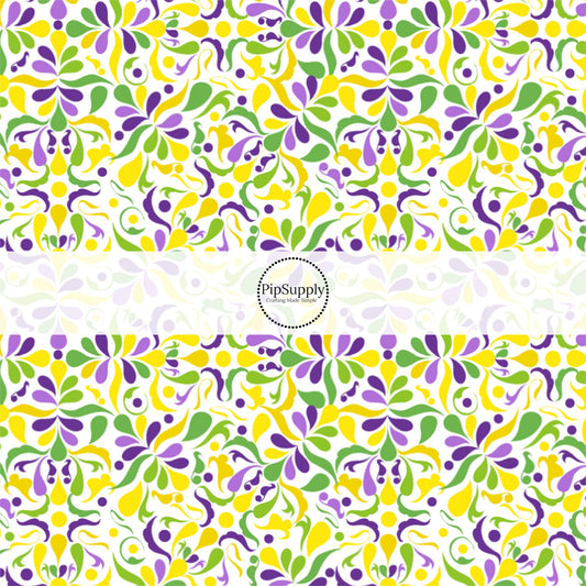 Yellow, purple, and green paisley print on white fabric by the yard.