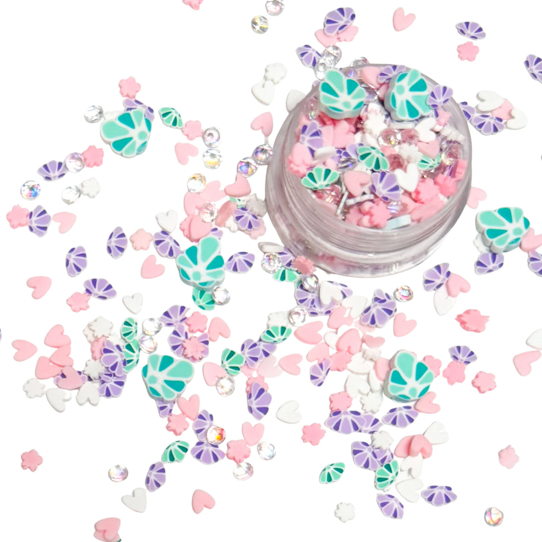 These Mermaid Shells Clay slices are versatile for many festive craft projects. These clays are shaped as&nbsp; mermaid shell purple and green, clear rhinestones, and pink heart designed clay slices. You can use it to add sparkle and decoration to resin projects, filling for shaker bows, slime making, party decor, scrapbooking, card making and nail art.

One bag is 1 OZ&nbsp;
Bags are resealable for repetitive use