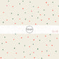 Cream fabric by the yard with red and green speckled dots.
